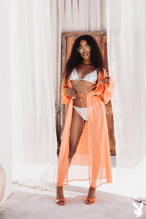 Mia Love Unties A Papaya Print Bikini Between Clay Jars - Photo 00