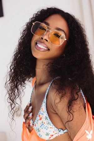 Mia Love Unties A Papaya Print Bikini Between Clay Jars - Photo 02