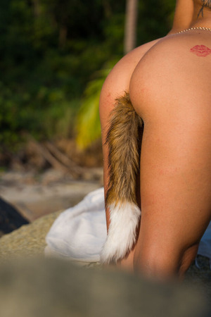 Chica Minori nude photo 11 - Chica Minori Plays With A Fox Tail Plug On A Tropical Beach